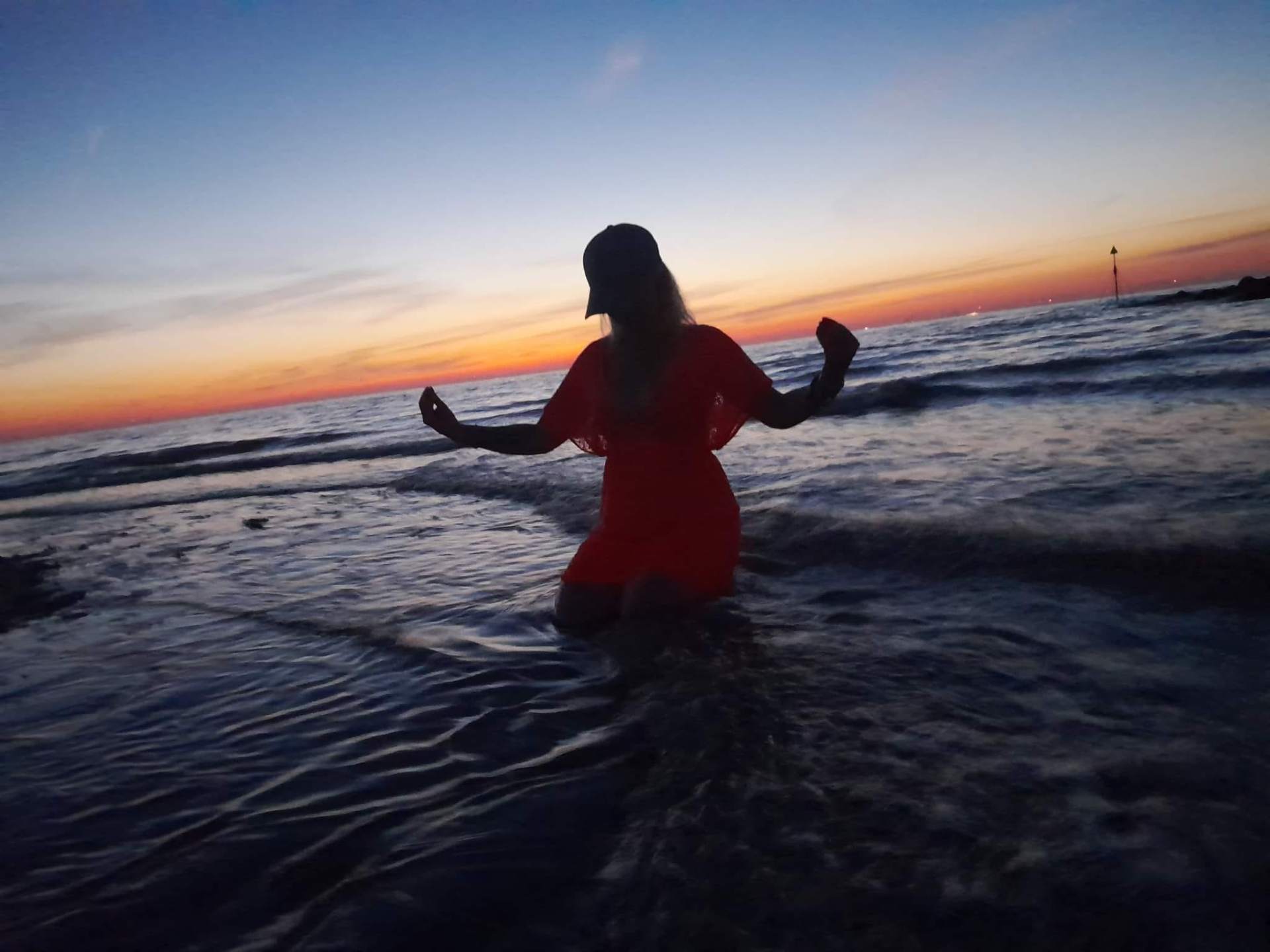 Kami at the sea at sunset — moment of stillness